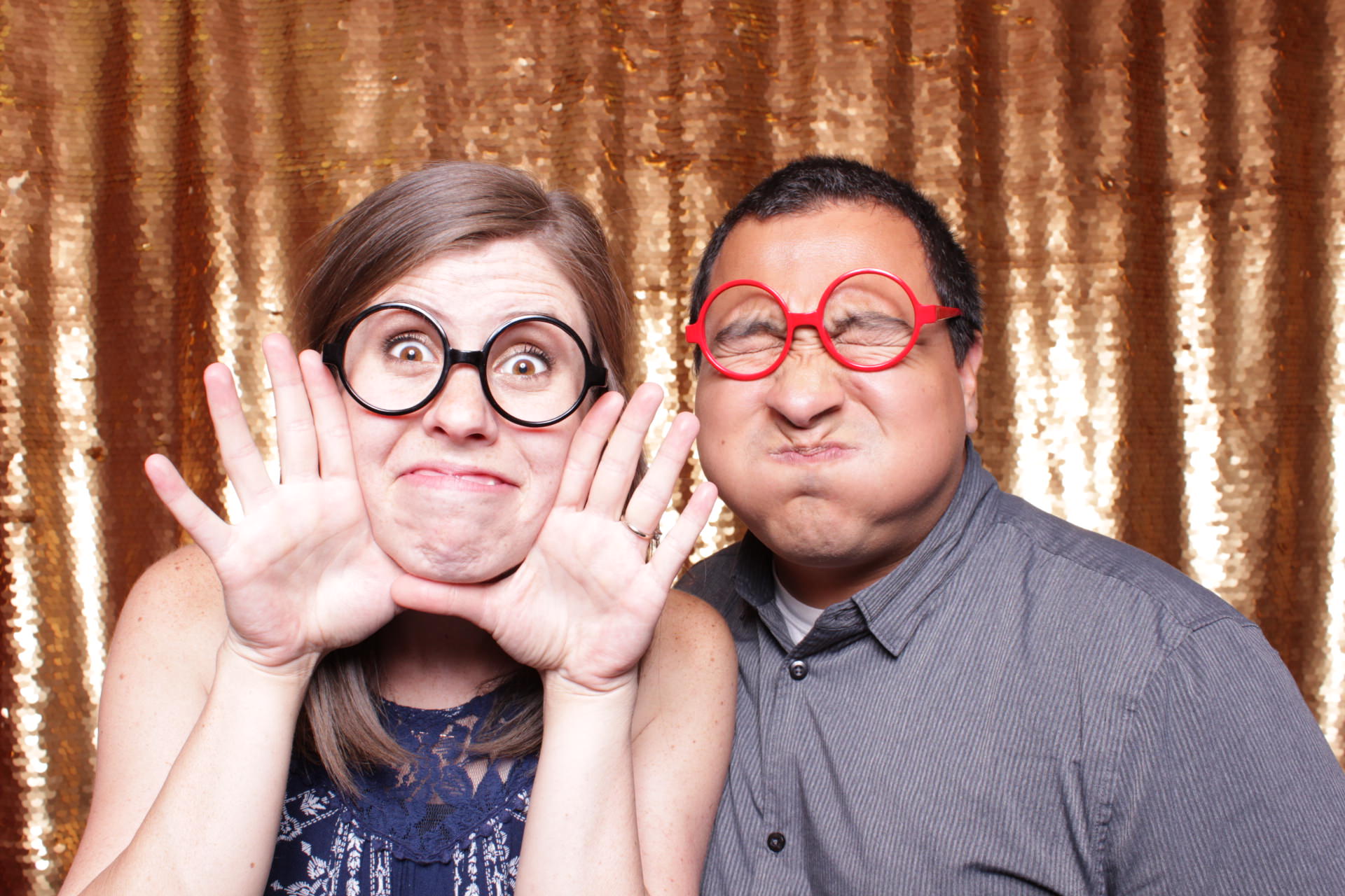 couple makes silly faces in a Fresno photo booth