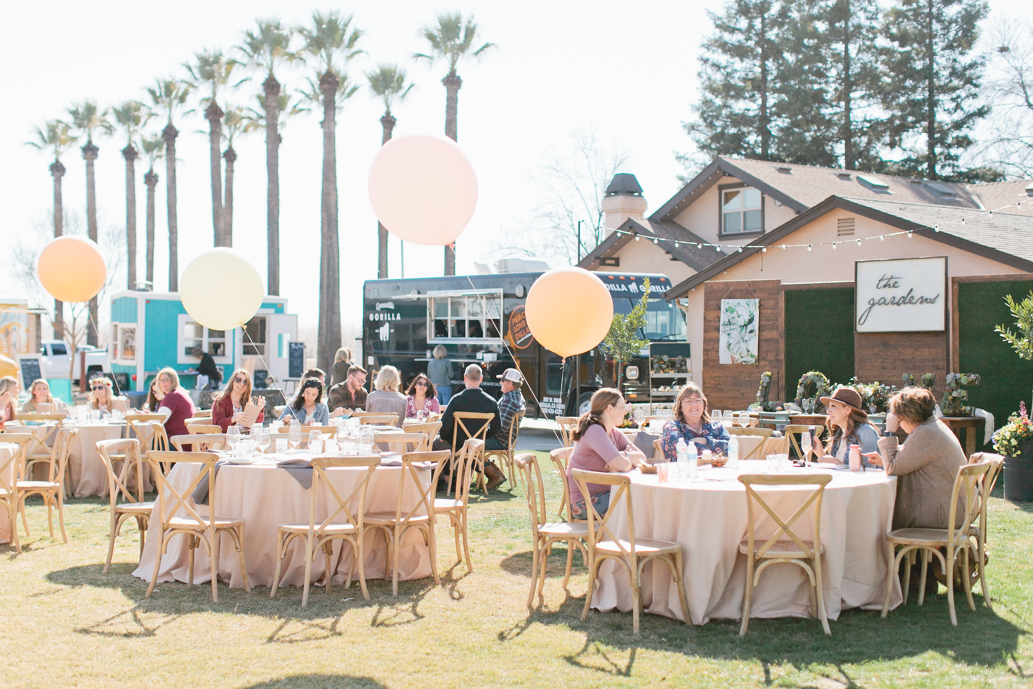 lunch tables with giant balloons at bridal event milk and honey