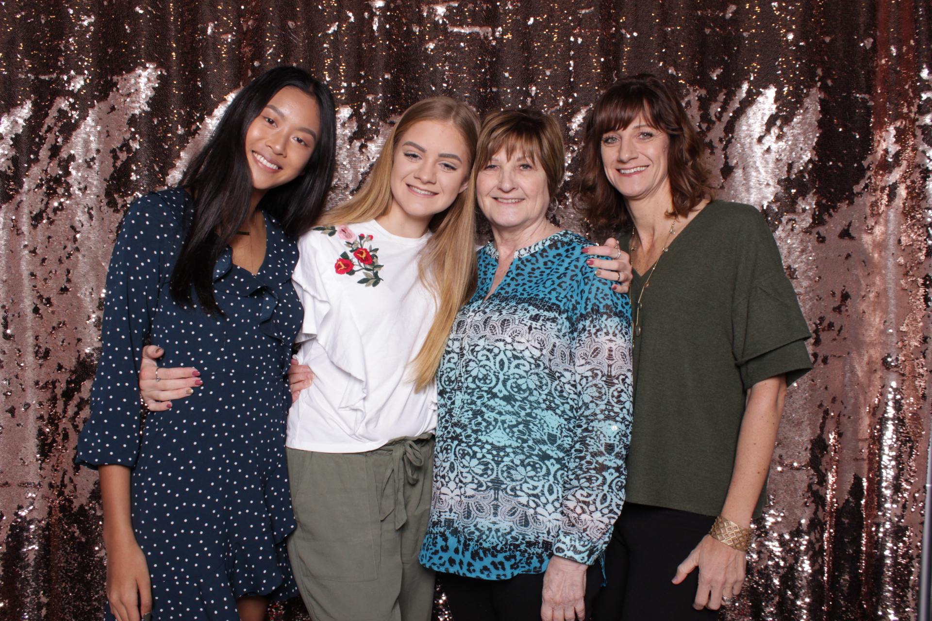 daughter and moms take photo in photo booth at fight with fashion