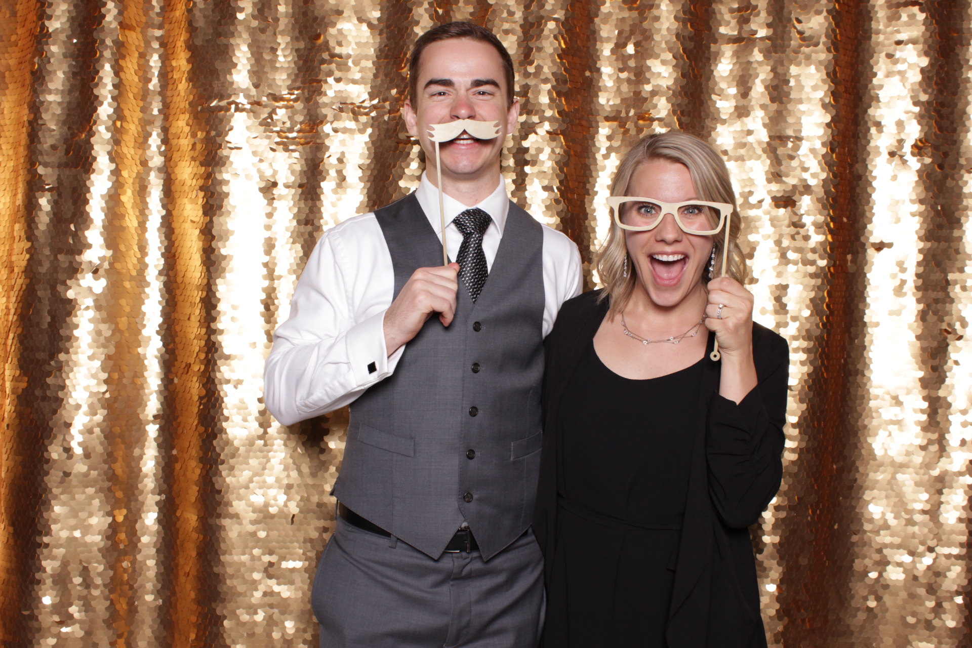 husband and wife posing in the photo booth