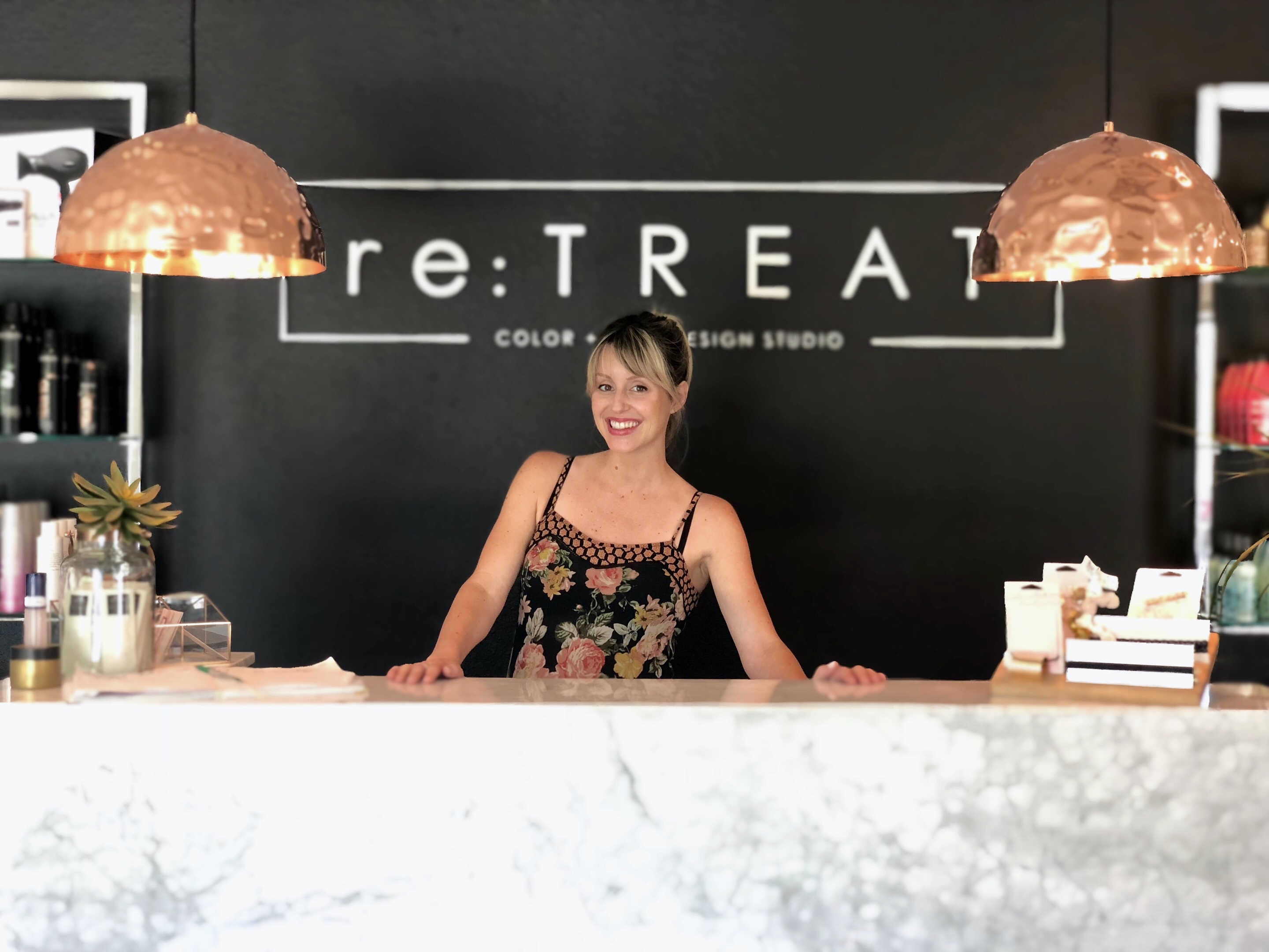 Anna greets guests at retreat hair studio in clovis