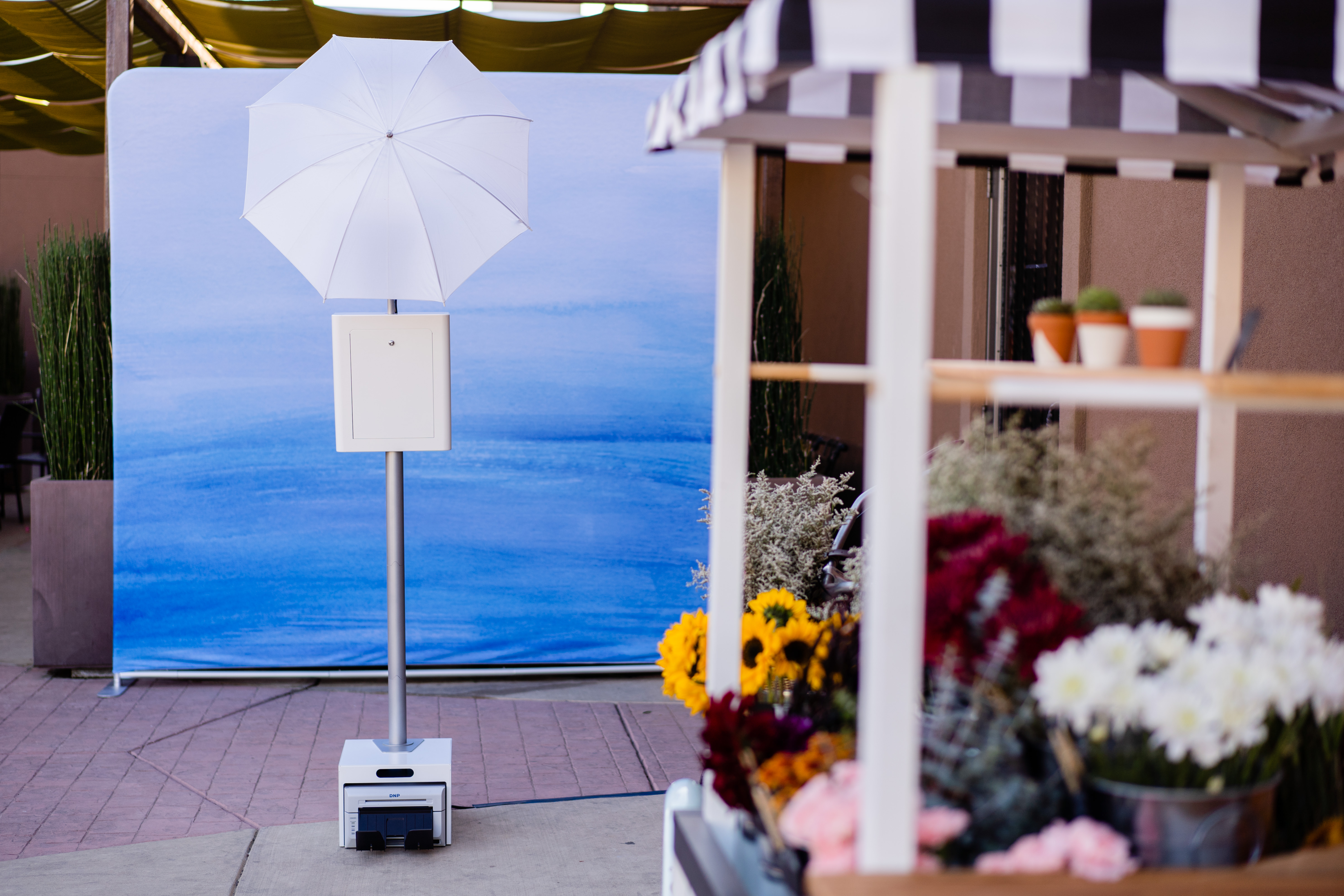 red brick photo booth with flower flower cart